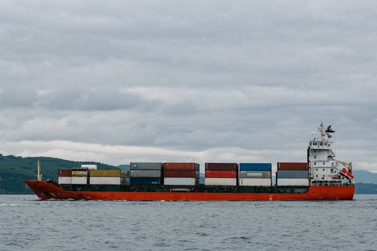 about-01 Container ship navigating the waters of Kamchatka, Russia, against a cloudy sky.
